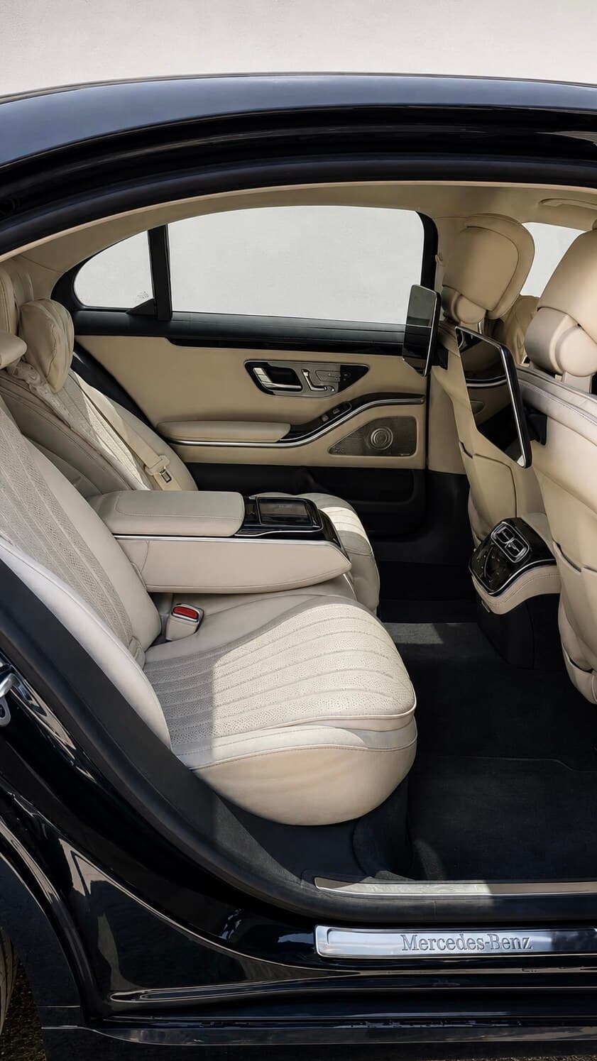 Mercedes-Benz S Class rear seat interior with executive seating, MBUX rear tablet, and ambient lighting — luxury limousine hire in Bangalore