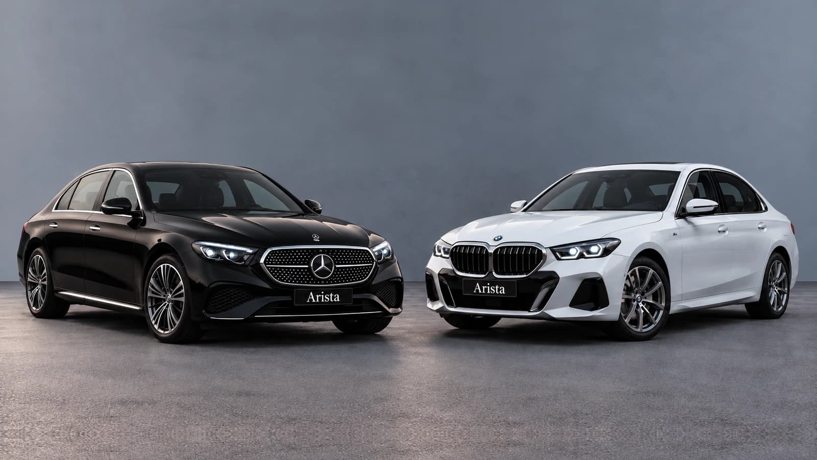 Black Mercedes-Benz E-Class and white BMW 530Li parked side by side
